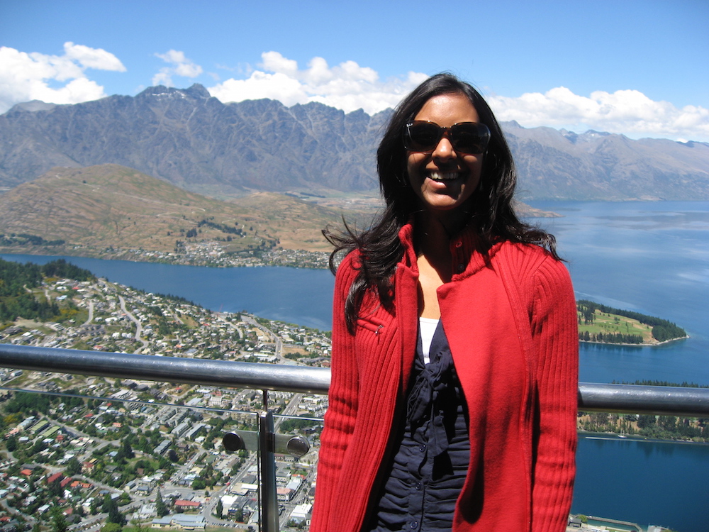 women standing with Queenstown, New Zealand in the background
