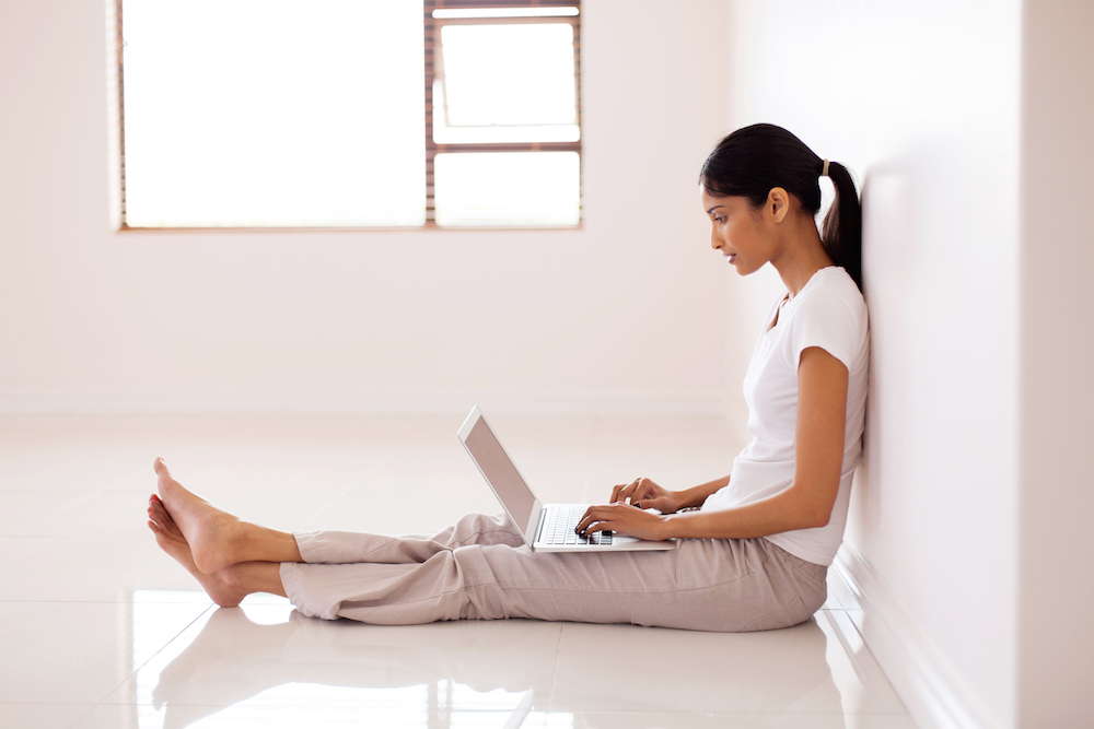 woman wearing white blouse and pants on computer